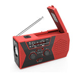 Solar powered hand charging NOAA radio with flashlight reading light in the United States