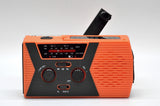 Solar powered hand charging NOAA radio with flashlight reading light in the United States