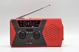 Solar powered hand charging NOAA radio with flashlight reading light in the United States